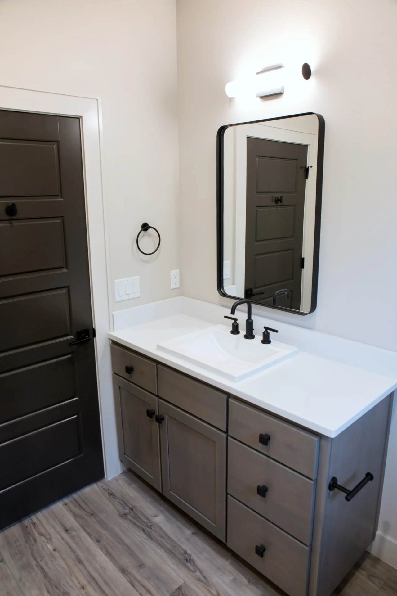 bathroom with rounded mirror and white sink