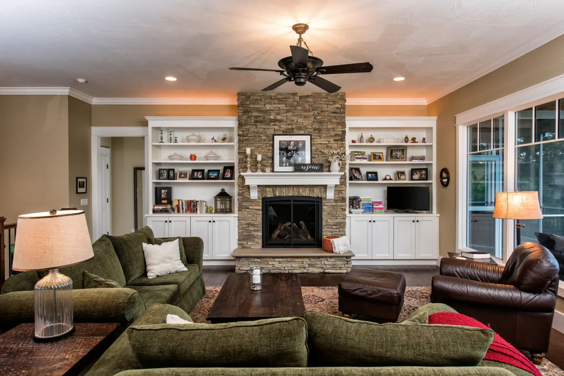 Large living room with armchairs and couches with a fireplace