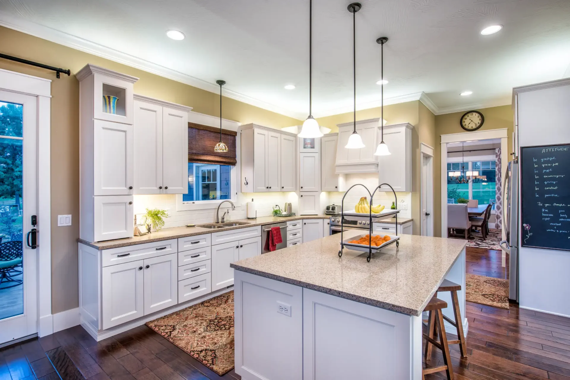 large kitchen with marble tabletop and white cabinets