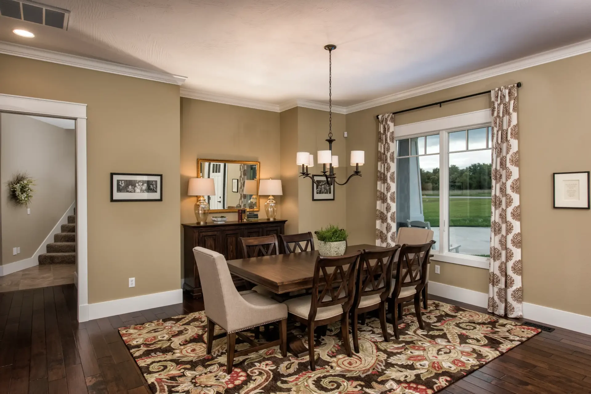 large dining room with hallway leading to stairs and large window