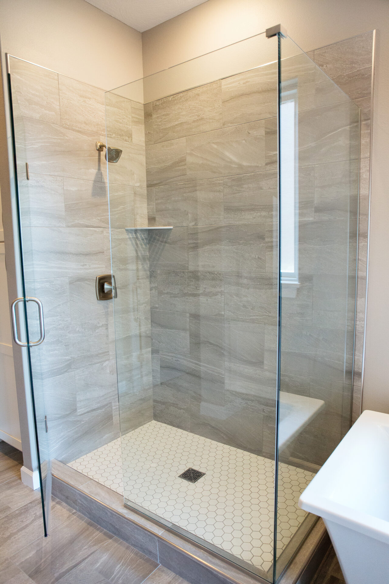 large glass shower with no slip mat