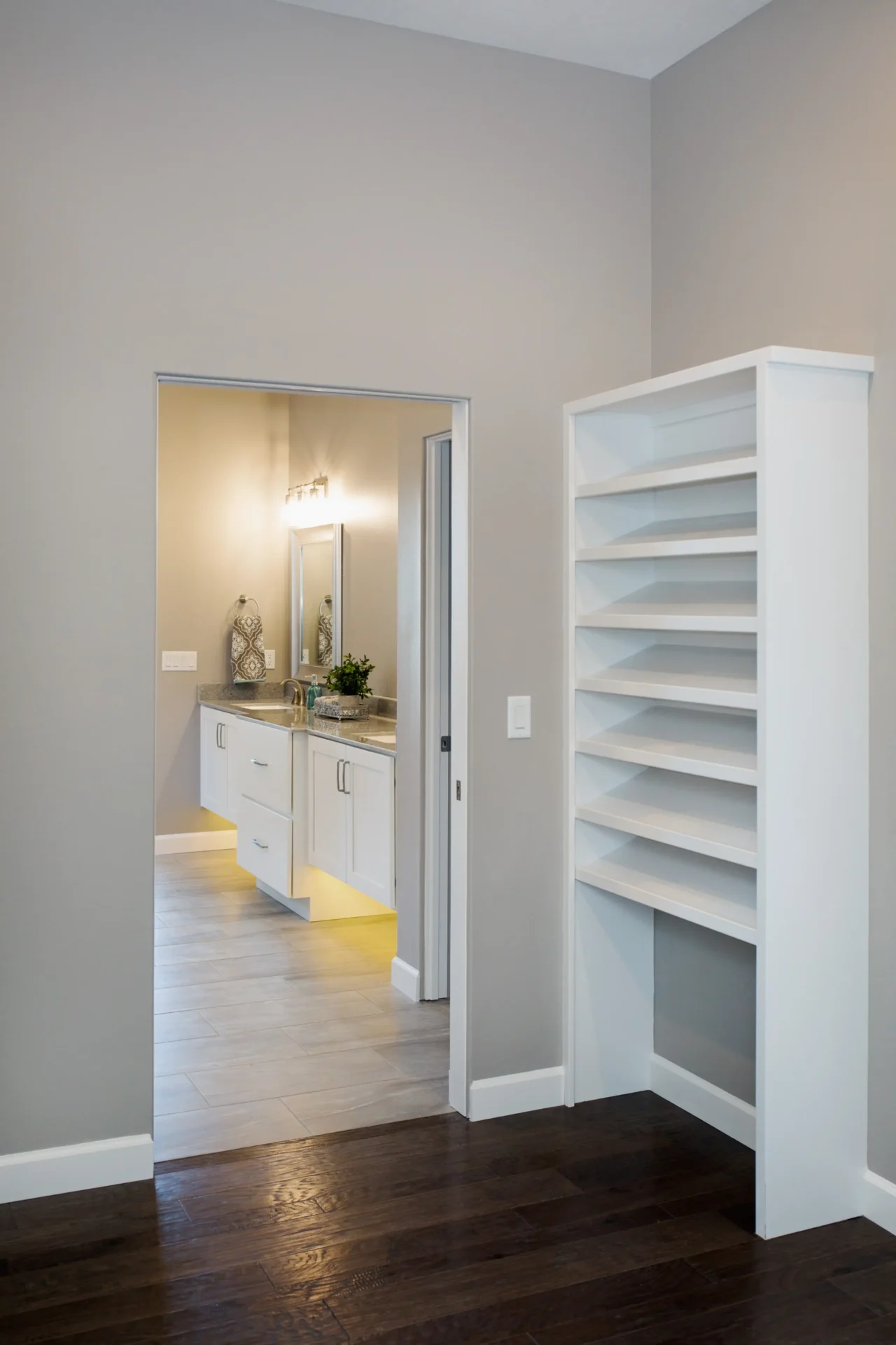 large bathtub with white shelving