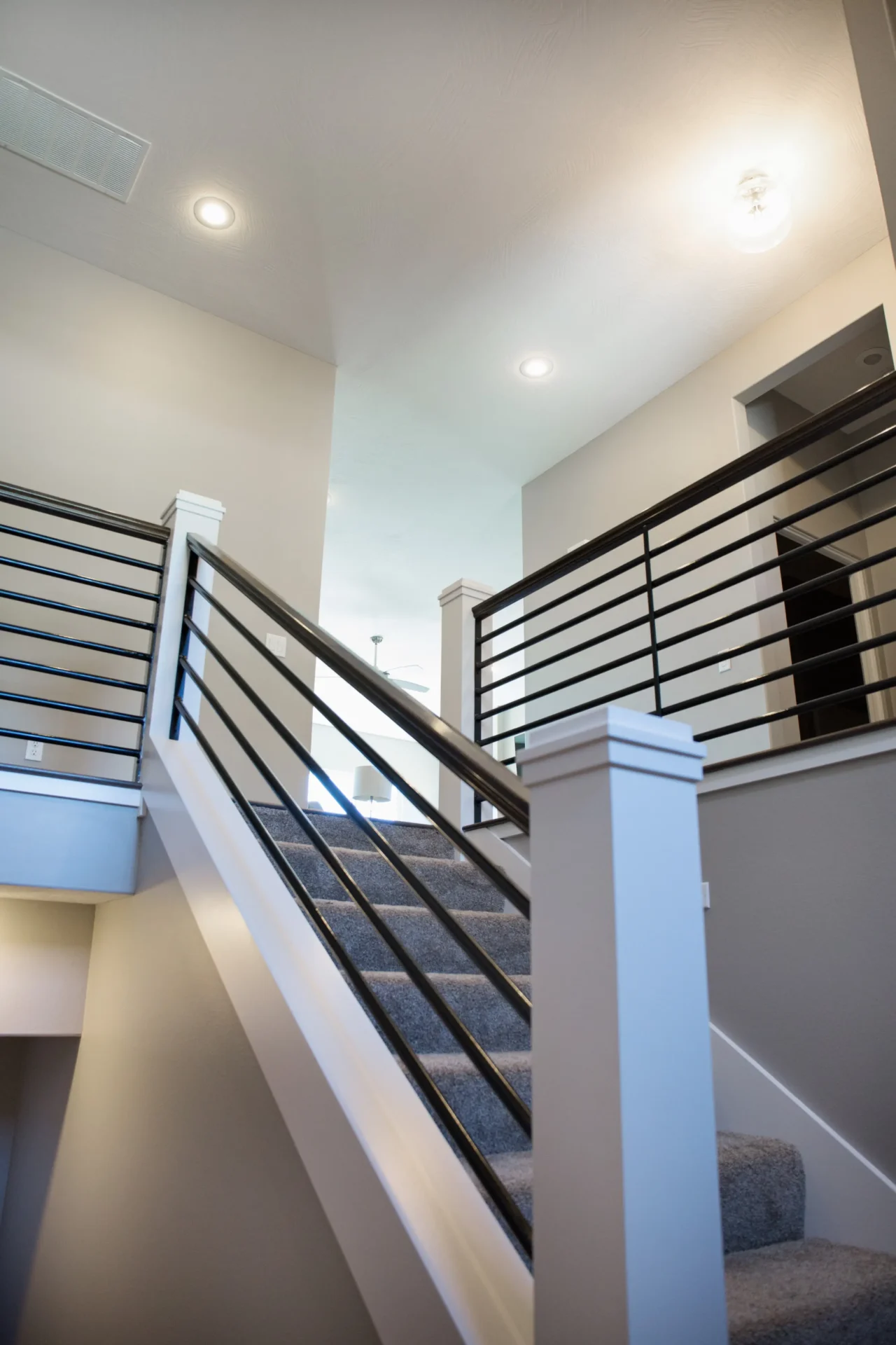 wooden banister with carpeted stairs