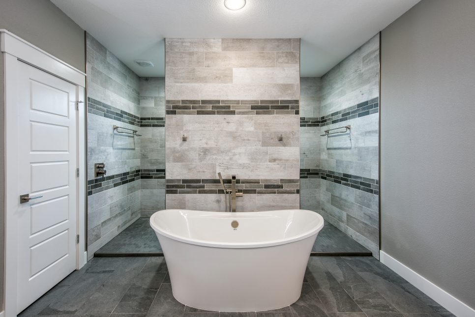 stone tiled bathroom with small bathtub
