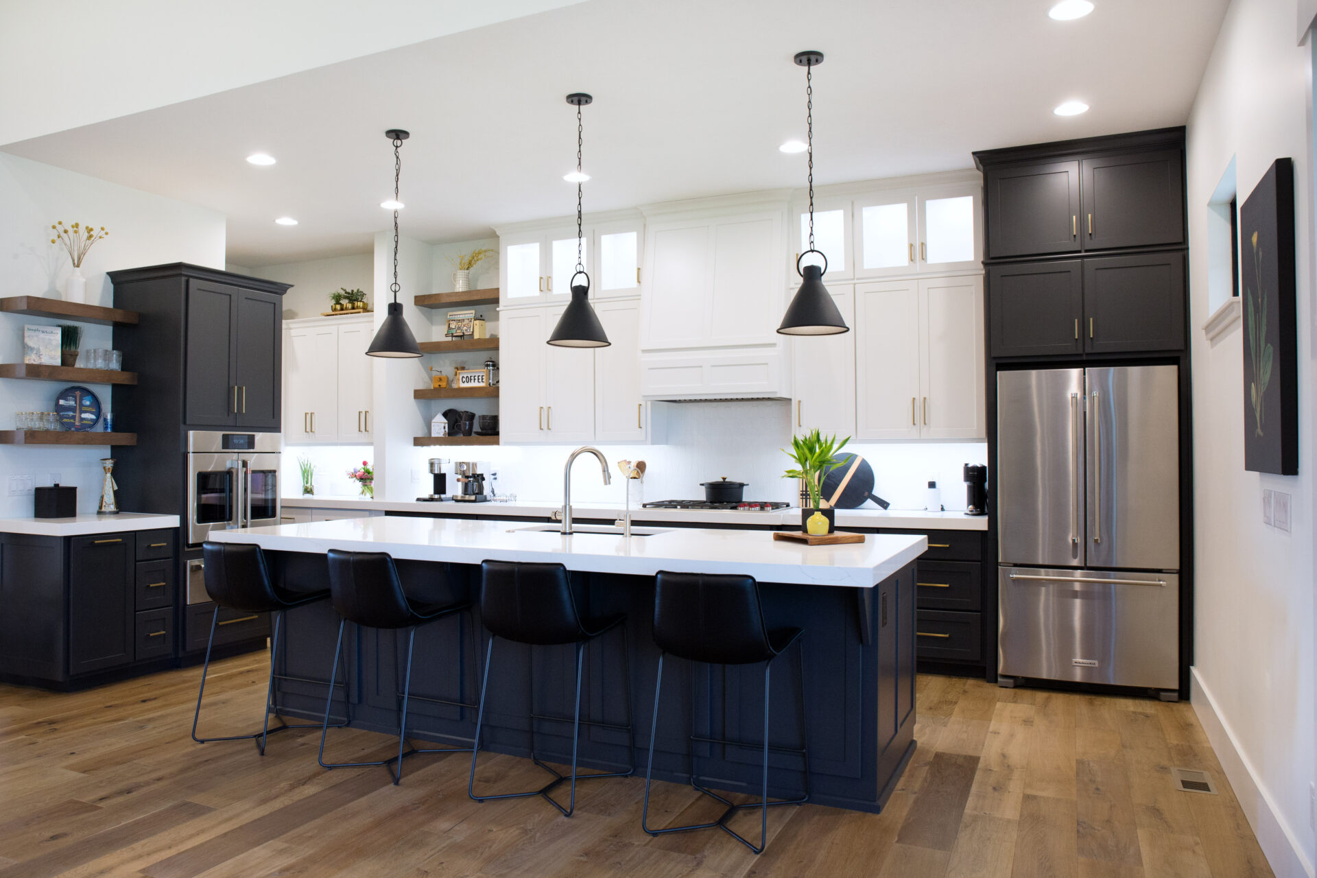 A spacious kitchen with black and white cabinets